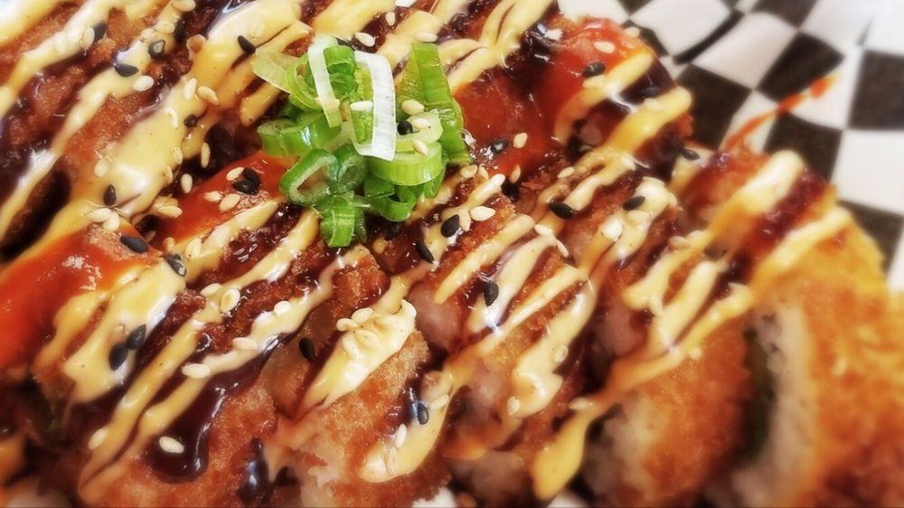 Dynamite Roll · Spicy tuna, cream cheese and jalapeno. Panko-fried and topped with spicy mayo, Sriracha, green onion and sesame.