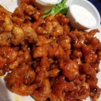 Voodoo Crawfish Tails · Spicy. Ohh, you taste buds gonna be tanking you dawlin’! Tender crawfish tails beer-battered...