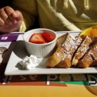 French Toast · Texas style with powdered sugar and butter. Add bacon, sausage or ham for an additional char...