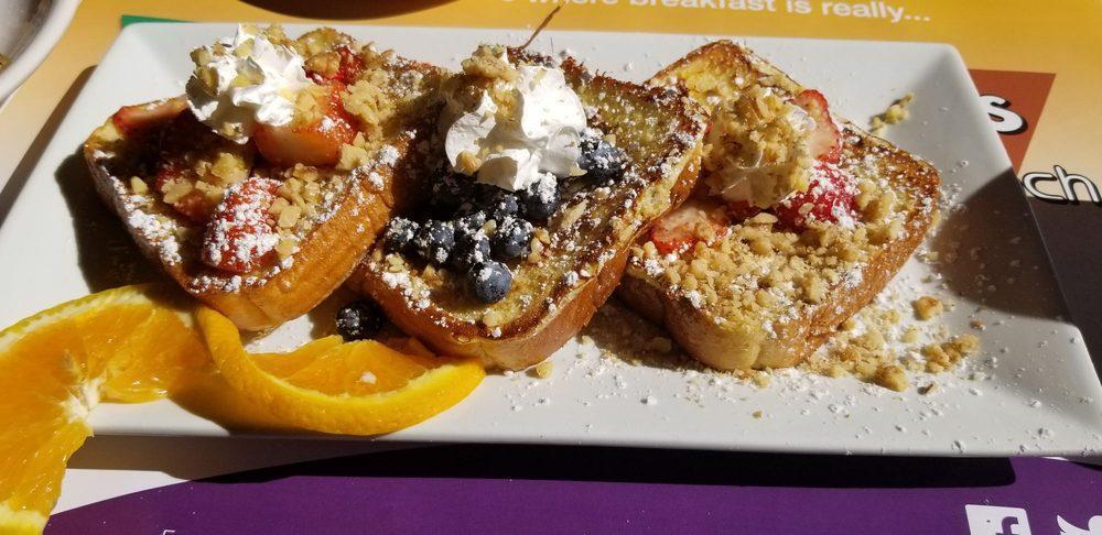 French Riviera · 3 pieces of French toast overstuffed to the max with strawberries, bananas, blueberries, topped with whipped cream and nuts.