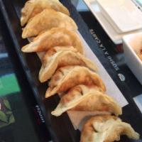 Gyoza · Deep-fried potstickers filled with pork and vegetables, and gyoza dipping sauce. 8 pieces.