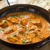Chicken Tikka Masala · Marinated boneless chicken cubes baked in clay oven and then cooked in creamy onion and toma...