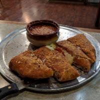 Calzone · A tasty meal consisting of our specialty ricotta cheese mixture, mozzarella cheese and a tou...