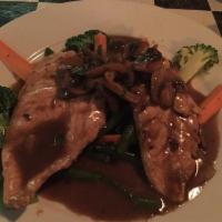 Chicken Marsala · Battered and pan-fried chicken in a slow-simmered mushroom and Marsala wine sauce. Served wi...
