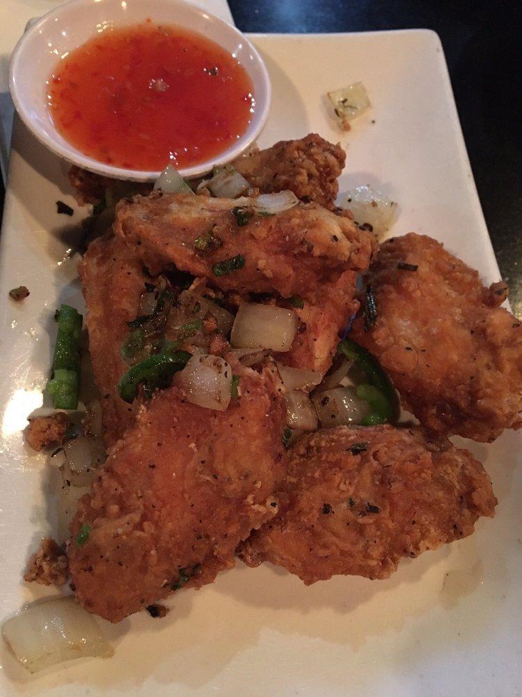 Salted Pepper Chicken Wings · Cooked wing of a chicken coated in sauce or seasoning.