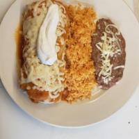 Burrito Suizo · Topped with ranchero sauce and melted cheese. Served with rice and beans. Comes with lettuce...