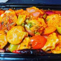 Chicken Chili Momo · Filling and wrap same as steamed and tossed with green chillies, green bell peppers,red onio...