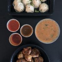 Chicken Jhol Momo · Filling and wrap same as steamed momo.Served with a bowl of hot liquid chutney soup on the s...