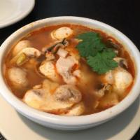 Tom Yum Soup · Famous Thai hot and sour soup with mushrooms in a tart lime broth seasoned with lemon grass ...