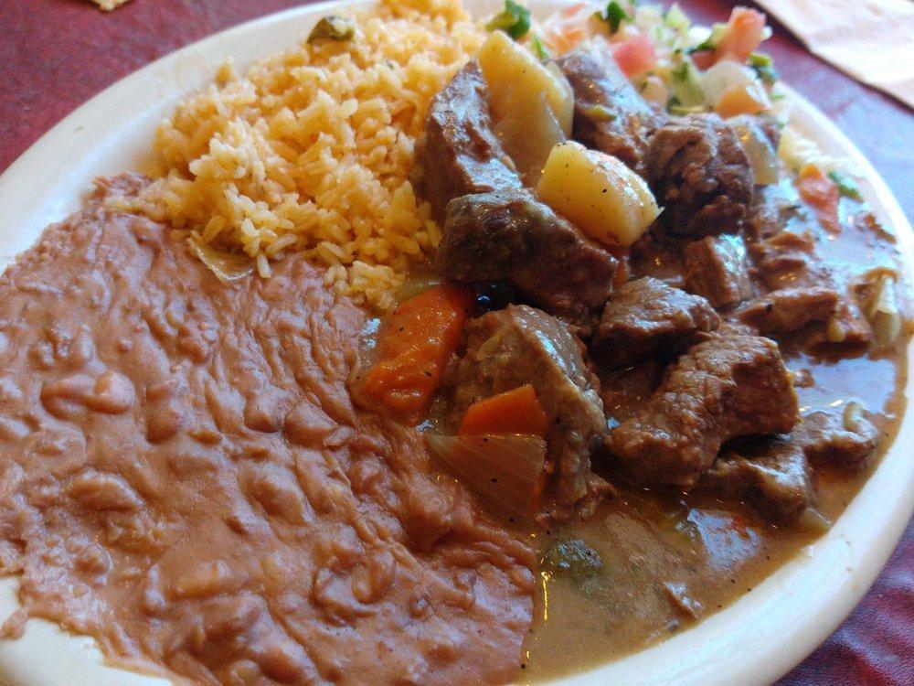 Carne Guisada · Stewed beef with vegetables, served with rice, beans, and pico de gallo.