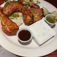 Tandoori Chicken · Chicken leg quarters marinated in fresh spices, herbs and yogurt, barbecued over flaming cha...