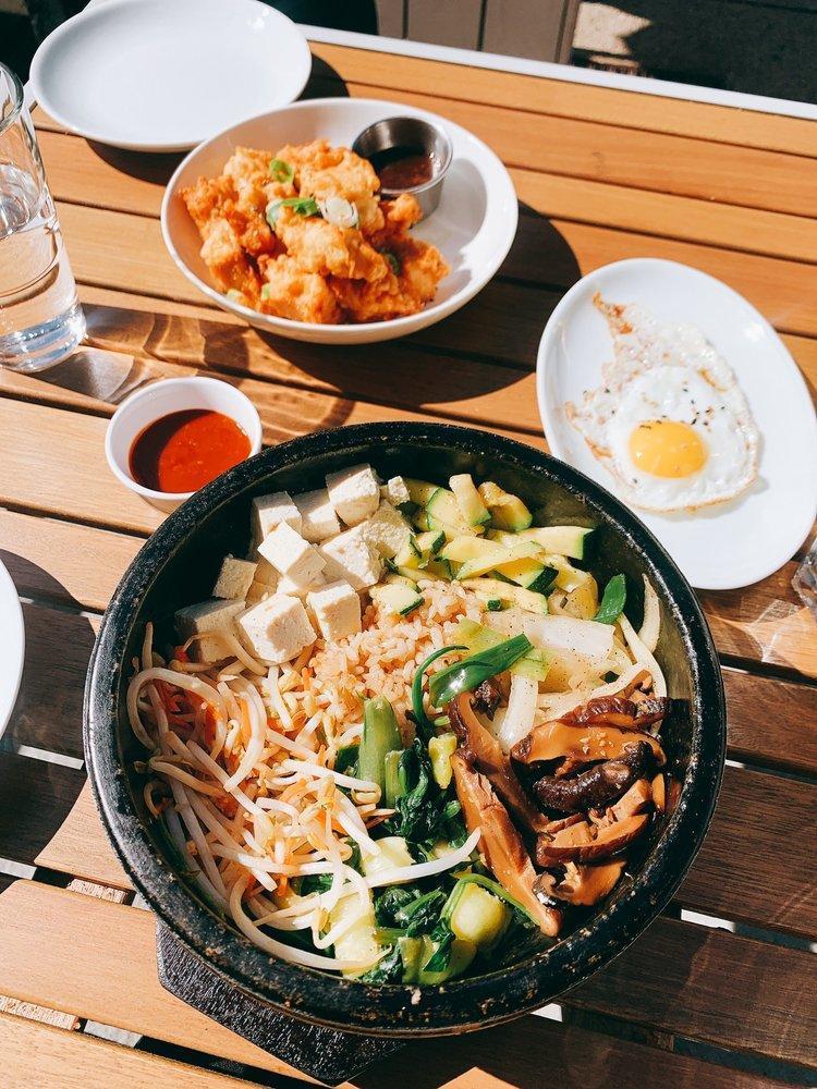 Dolsot Bibimbap Plate · Choice of rice with 9 vegetables (spinach, shaghai tips, onions, scallions, sprouts, carrots, zucchini, shiitake mushrooms) & fried egg. 
Choose protein: beef, spicy pork (not gluten free), or tofu. 
Gluten free ingredients. 
Spicy bibimbap sauce is not gluten free.