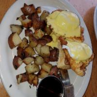 Chicken and Waffle Benedict · Crispy chicken, poached eggs and hollandaise sauce on a Belgian waffle with maple syrup serv...