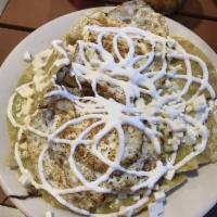 Chilaquiles · Lightly fried corn tortillas simmered in green sauce. Fried egg or choice of meat. Topped wi...