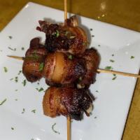 Datiles · Bacon-wrapped dates stuffed with Monterrey Jack cheese.