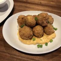 Loaded Potato Croquettes · Aged white cheddar mash with bacon and chive, rolled in panko and fried golden brown, served...