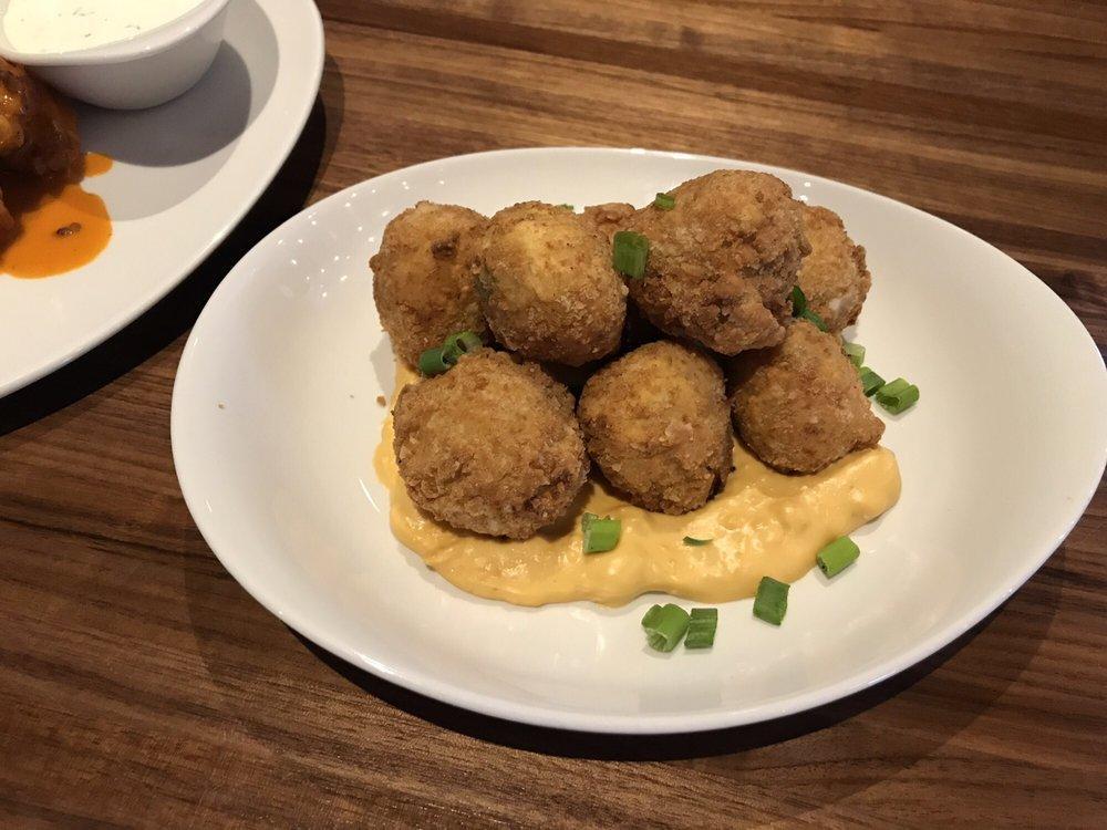 Loaded Potato Croquettes · Aged white cheddar mash with bacon and chive, rolled in panko and fried golden brown, served with a cheddar cheese sauce.