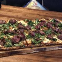 Prime Beef Flatbread · Prime beef steak sautéed with caramelized onions, mozzarella and bleu cheese, topped with ar...