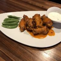 Buffalo Wings · Tossed in your choice of our house-made sauces: Range buffalo wing sauce, Asian barbecue sau...
