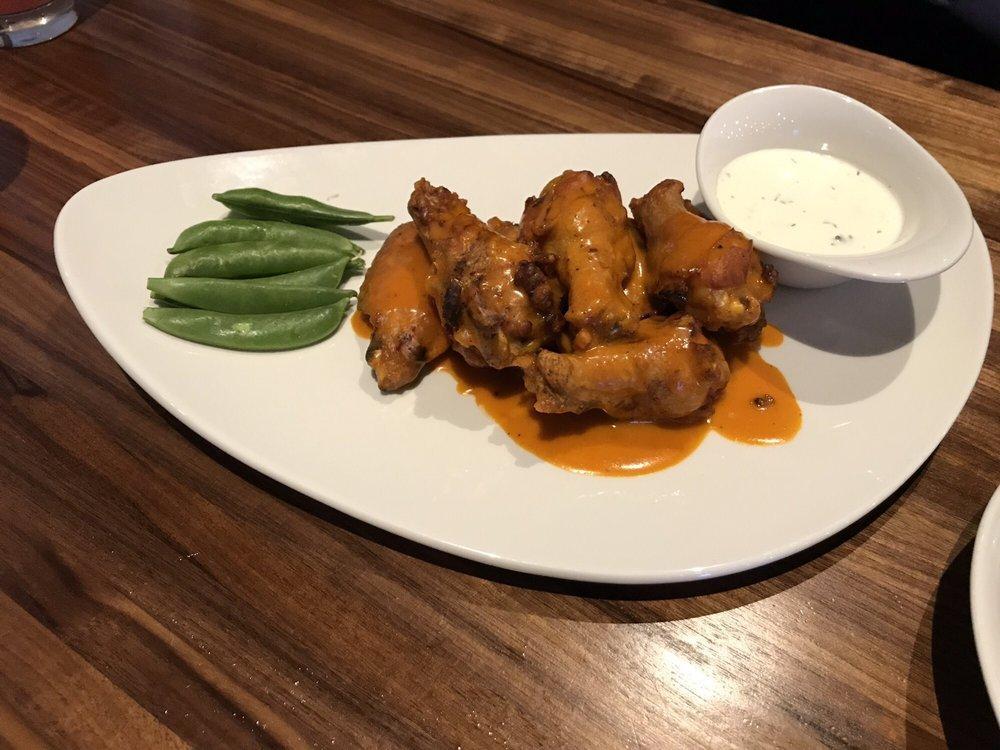 Buffalo Wings · Tossed in your choice of our house-made sauces: Range buffalo wing sauce, Asian barbecue sauce or habanero sauce, served with snap peas and ranch dressing