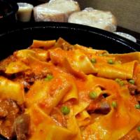 Pappardelle Buttera · Sweet and spicy sausage, English peas, sage and vodka sauce.