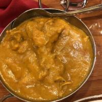 Chicken Coconut Curry · Boneless chicken thigh chops cooked with coconut milk, fresh tomatoes, cashew nuts, golden r...