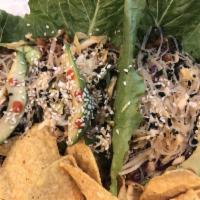 Asian Tacos · Vegan protein beef, sliced avocado, shredded cabbage, fresh
herbs, vermicelli noodles, sesam...