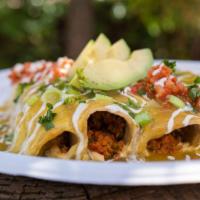 Green Chili Enchiladas · Vegan protein beef, zucchini, sauteed peppers and onions wrapped in corn tortillas topped wi...