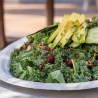 Coconut Kale Salad · Kale, coconut bacon, dried cranberries, cucumbers, scallions and sliced avocado tossed in a ...