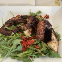 Octopus · Grilled octopus on a bed of baby arugula, sun-dried tomatoes and topped with balsamic glaze.