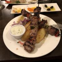 Lamb Souvlaki · Pork cubed, skewered with peppers and onions. Chargrilled. Gluten-free.