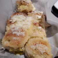 Garlic Rolls · Smothered in  garlic and butter topped with parmigiana cheese
