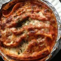 Lasagna · Pasta sheets layered with meat, homemade tomato sauce and our special blend of ricotta toppe...