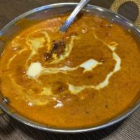 Butter Chicken · Boneless tandoori chicken cooked in creamy butter sauce, onions and bell peppers.