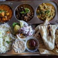 North Indian Thali · It's an 8 item combo meal served in a traditional India steel metal platter, Thali present t...