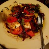 Caprese Salad · Fresh mozzarella, Roma and sun-dried tomatoes, fresh basil, Kalamata olives, olive oil and b...