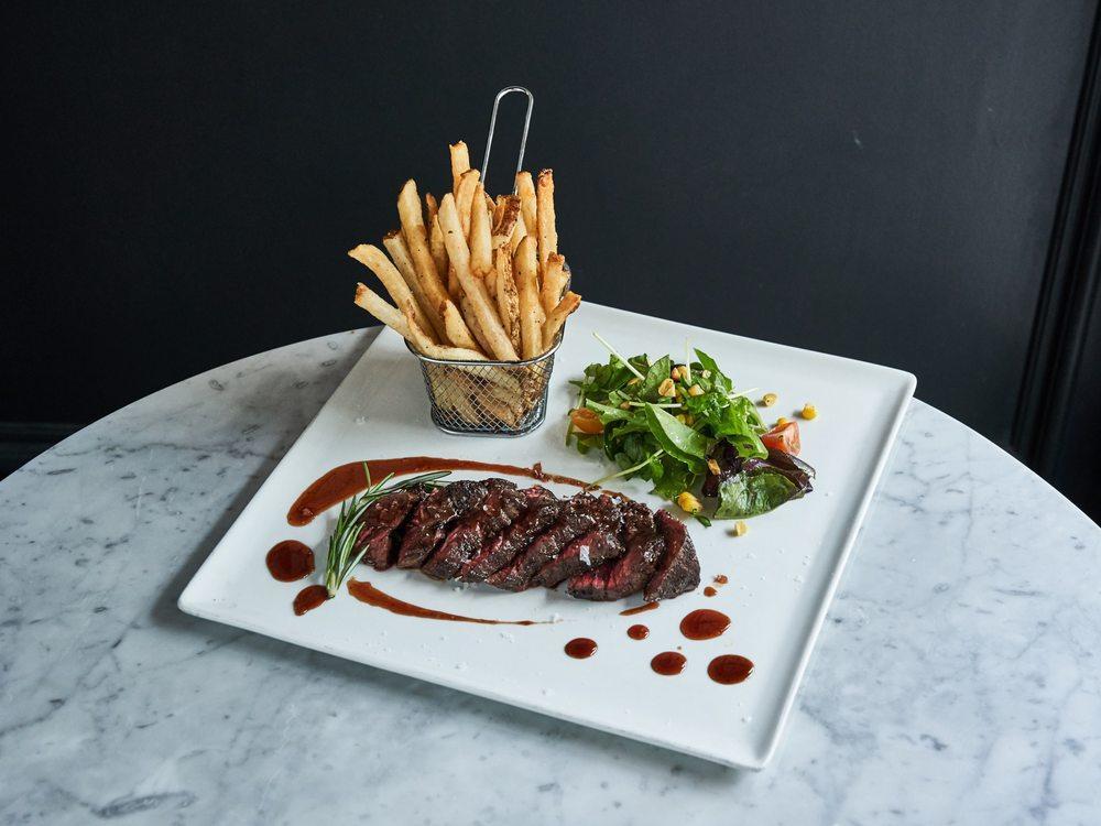 Steak Frites · Grilled hanger steak, Red wine reduction, Side frites and Mixed greens