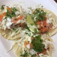 Fish Tacos · Breaded fish, with cilantro, onion, cabbage, tomatoes and dressing with salsa.
