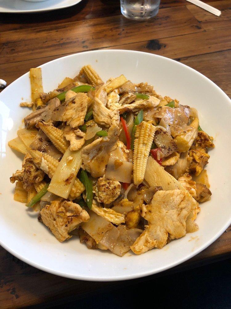Pad Kee Mao · Basil stir-fried with flat rice noodles with onions, red and green bell peppers, straw mushrooms, egg, baby corn, basil leaves and our special sauce. 