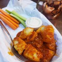 Boneless Wings · Breaded chicken breast baked chopped tossed and sauced. Served with carrots, celery, and cho...