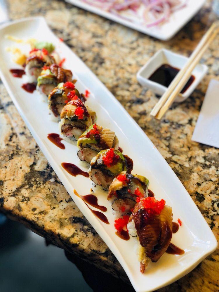 House Dragon Maki · Shrimp tempura, crab stick and eel sauce topped with eel, avocado, and masago.