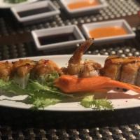 Dragon Roll · Shrimp tempura inside with eel avocado on top with eel sauce.