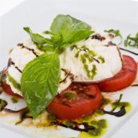 Caprese Salad · Made of sliced fresh burrata cheese, tomatoes and basil, served with balsamic glaze and pest...