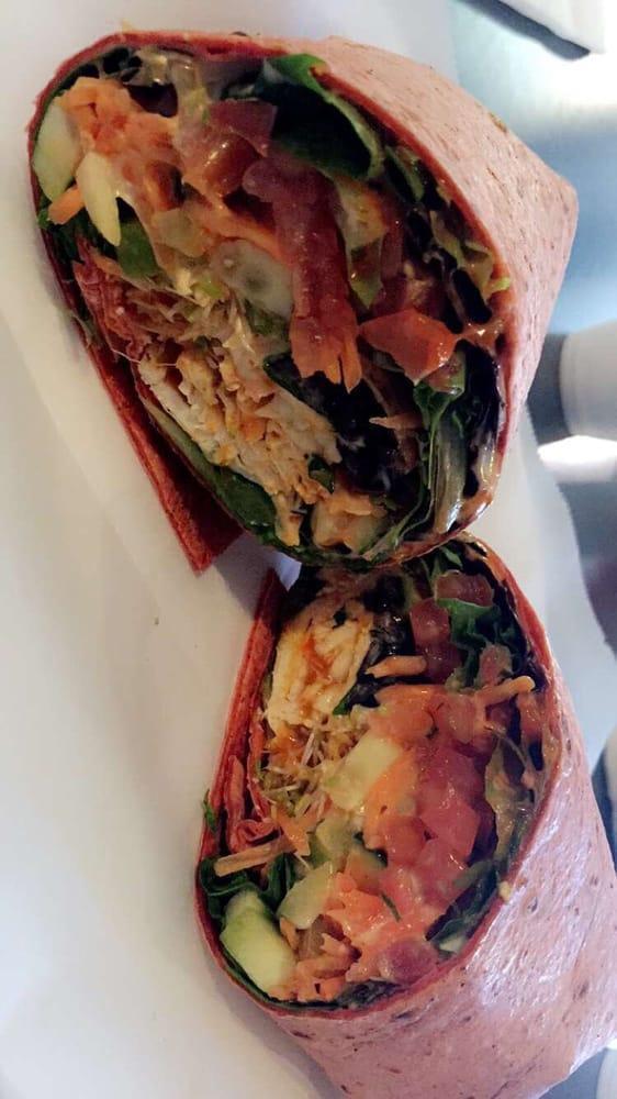 Buffalo Chicken Wrap · Buffalo sauce, chicken, bell peppers, cucumbers, olives, carrots, tomato, lettuce, sprouts and cilantro.