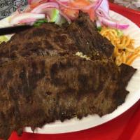 Carne Asada · Marinated and grilled thin beef steak with rice, beans and salad with 2 tortillas.