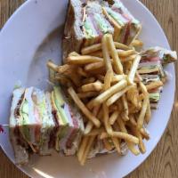 Club Sandwich · Sliced juicy ham, oven-roasted turkey breast, bacon, lettuce, tomato, and mayonnaise on sour...