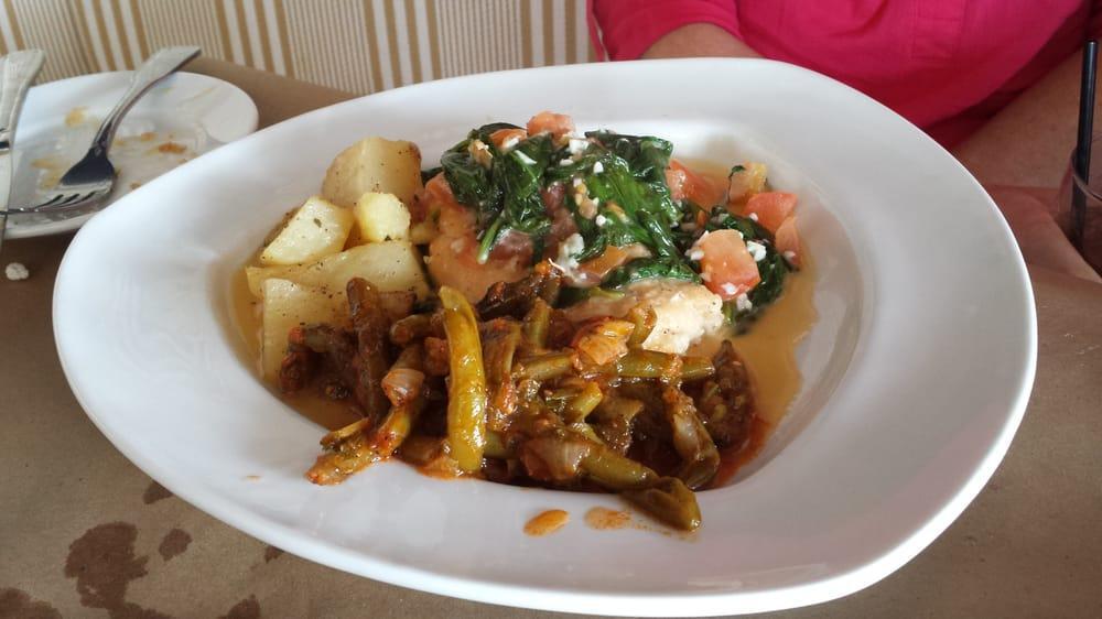 Chicken Corfu · Chicken breast sauteed in a lemon-white wine sauce with garlic, tomatoes and spinach.