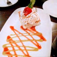 Hugo's Tres Leches · Gluten-free house-made sponge cake with almond, coconut, and condensed milk, and flaming Spa...