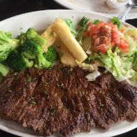 Carne Asada · A delicious 10 oz. wood grilled sirloin flap steak, marinated with our secret spices. Served...