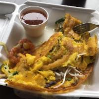 Banh Xeo · Crispy crepe with pork and shrimp.